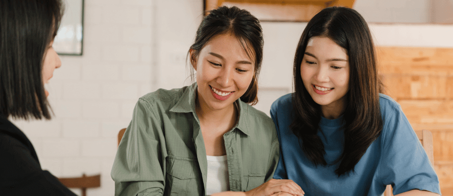 Young couple reviewing floor plans with their realtor