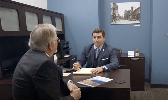 Eric Van Buskirk showing Private Banking materials to a client