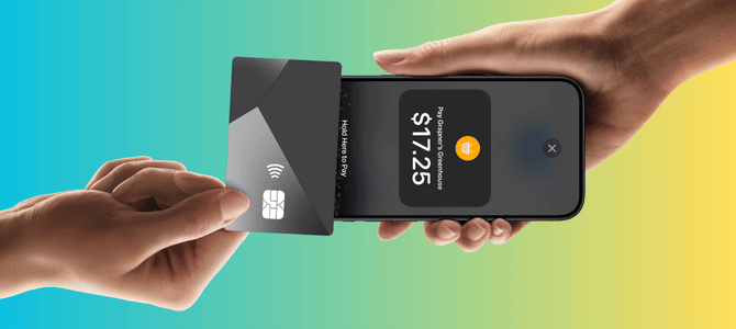 Person tapping their card to business owner's phone to make payment