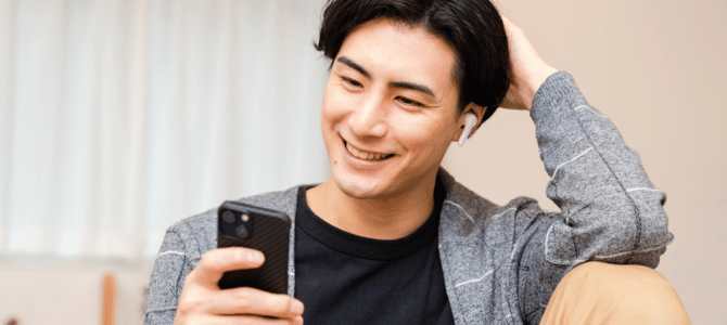 Man smiling at his smartphone