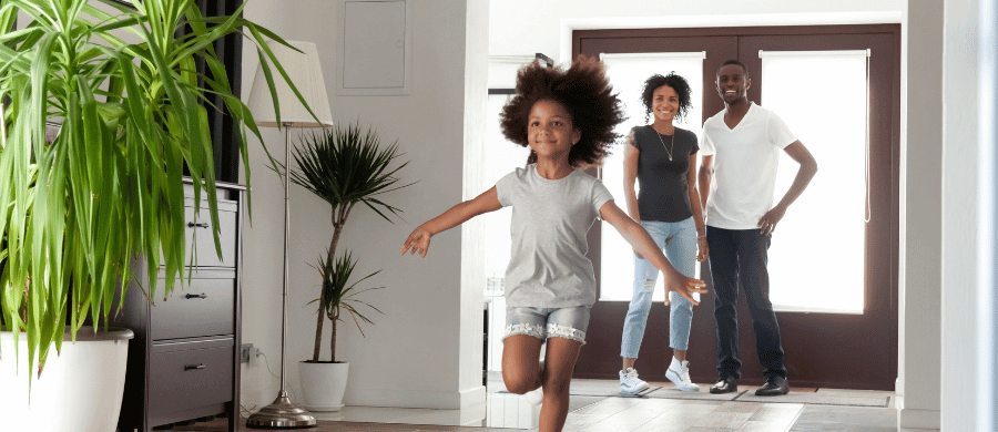 Family of 3 in the foyer of their luxury home